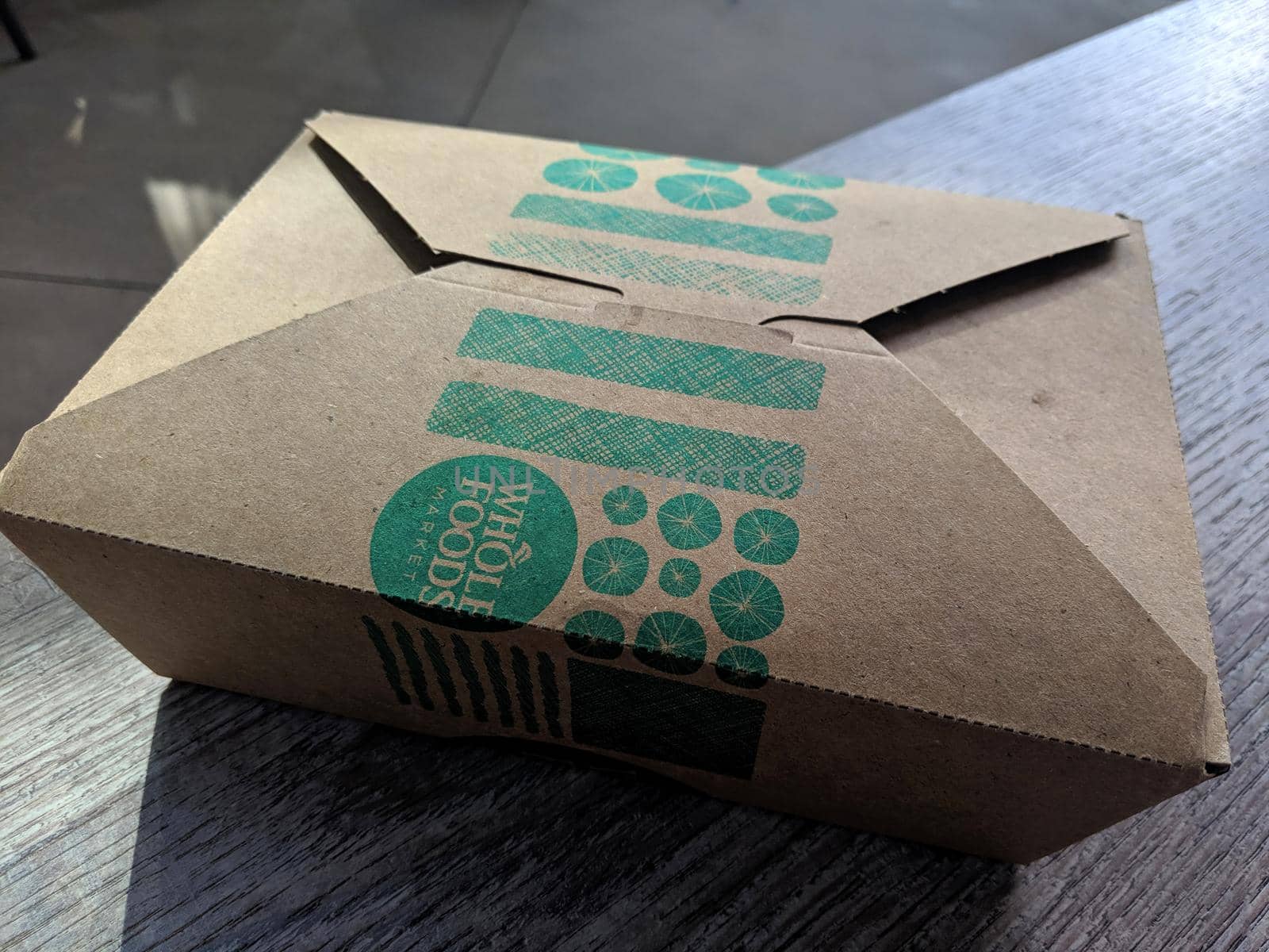 Honolulu - August 28, 2019:  Whole Foods Market To Go Container on table.