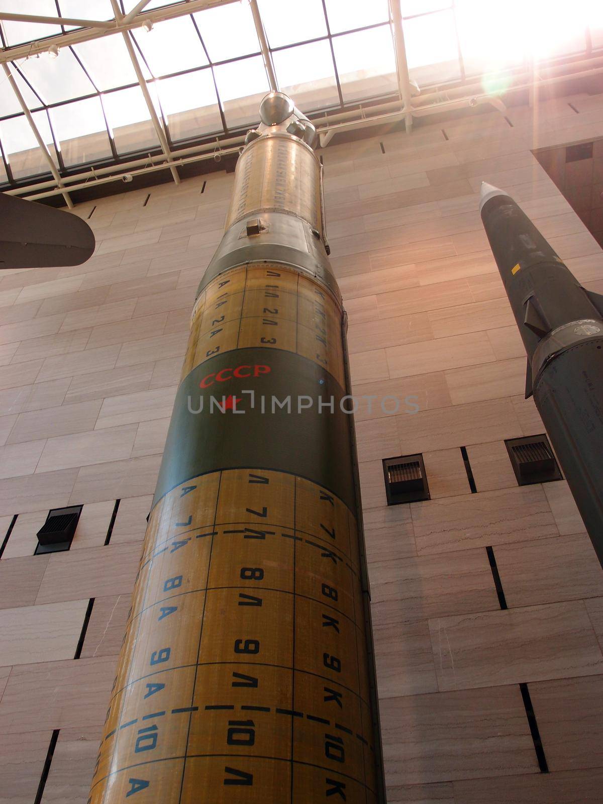 Washington, USA, - June 11,2014: The SS-20, known as the "Pioneer" in Russian, is a two-stage, solid propellant missile with three multiple targetable reentry warheads.

The missile is almost 16.5 meters tall. Painted on missile are the letters "CCCP" and a yellow five-point star.  The skylight in the National Air and Space museum is shining in sunlight in Washington which holds the largest collection of historic aircraft and spacecraft in the world.
