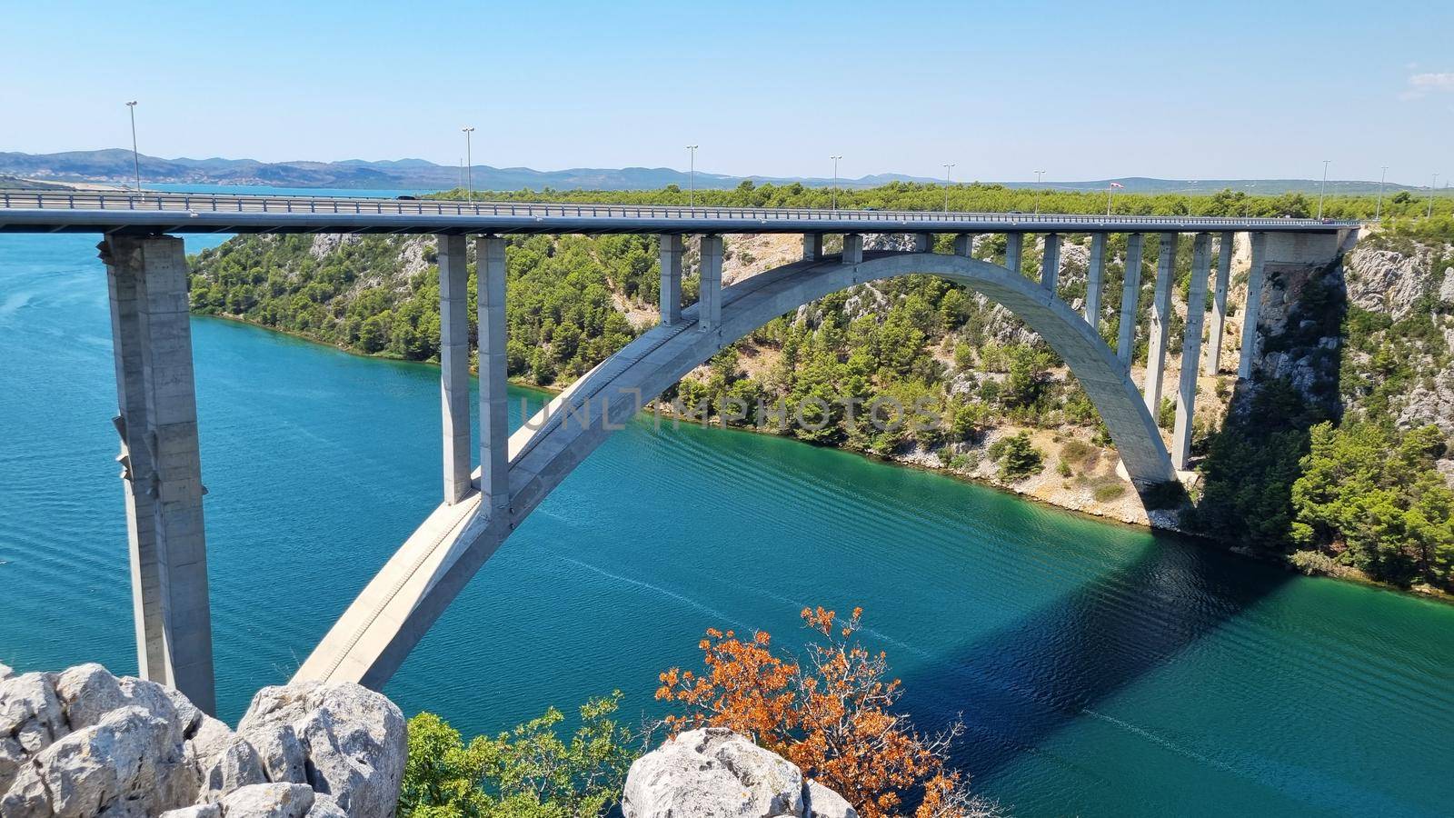 Highway Krka Bridge over the Krka river, town of Skradin in background, Croatia.