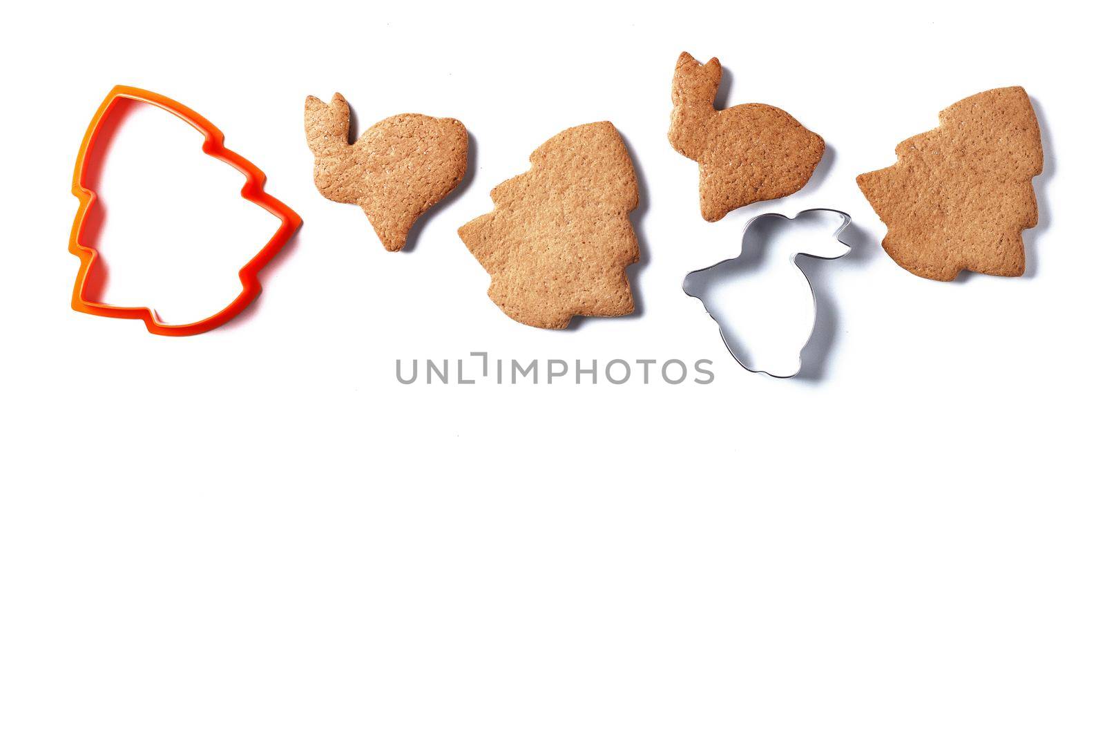 Ready-made Christmas cookies in the form of a rabbit and a Christmas tree with cookie cutters isolated on a white background. copy space. by lara29