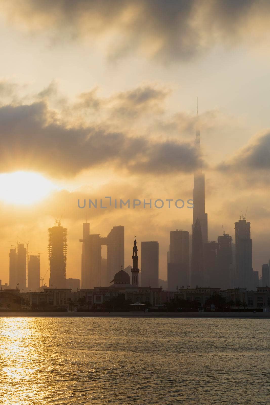 Dubai, UAE - 03.06.2021 Dubai public beach with city skyline on background.Sunrise hour. Outdoor by pazemin