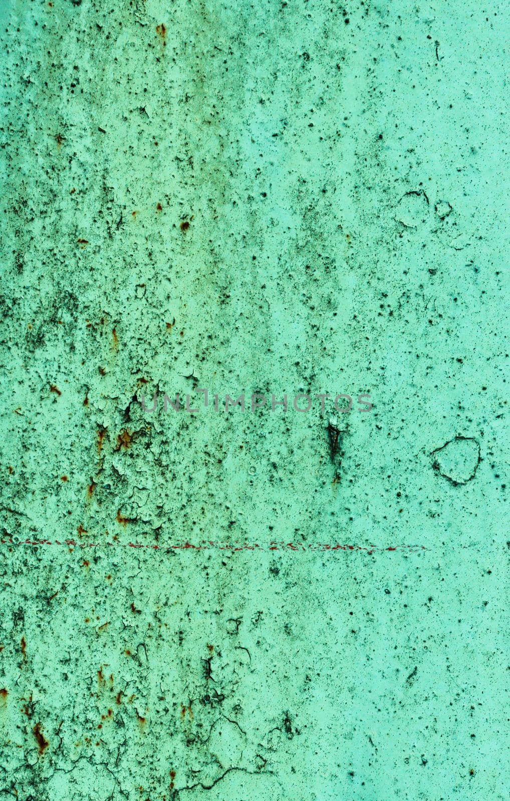 Abstract Background of peeling, cracked paint. Texture from a scratched surface with green paint damaged by time.