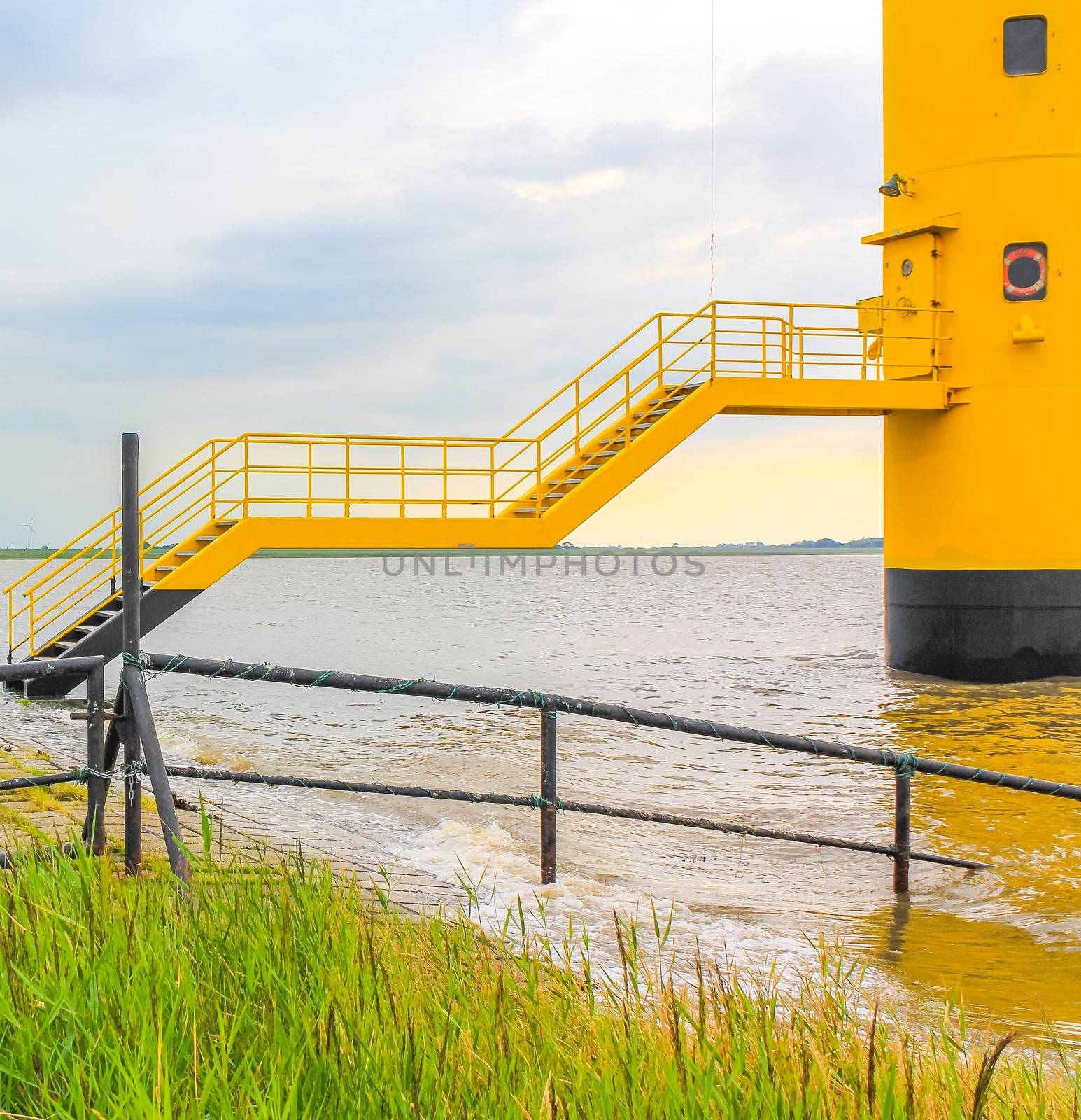 Dyke dike mudflat waves landscape North Sea coast Nordenham Germany. by Arkadij