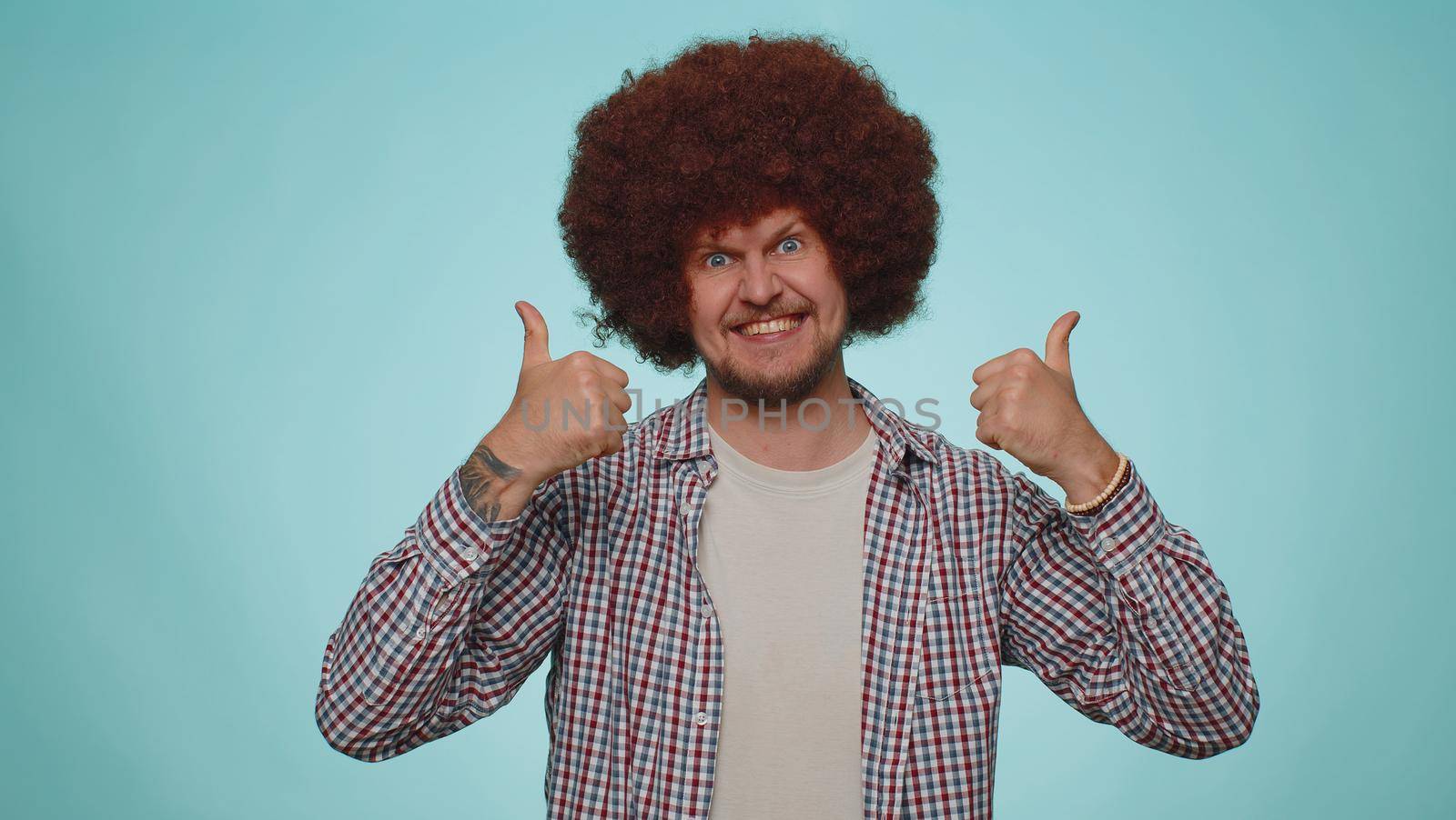 I am the best. Happy satisfied selfish haughty man proud of his victory, bragging own success win achievements, pointing fingers on himself with smile. Young adult guy boy on blue studio background