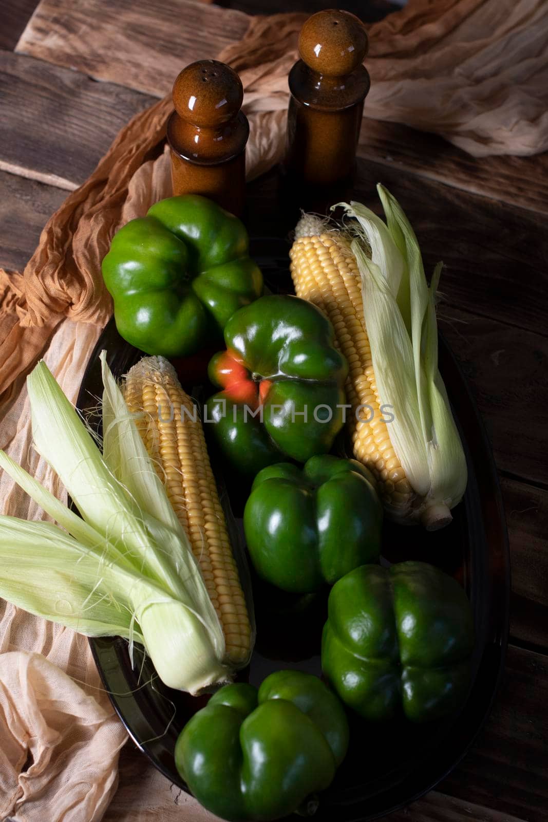 fresh green peppers with corn on wooden background autumn vegetables harvest. High quality photo