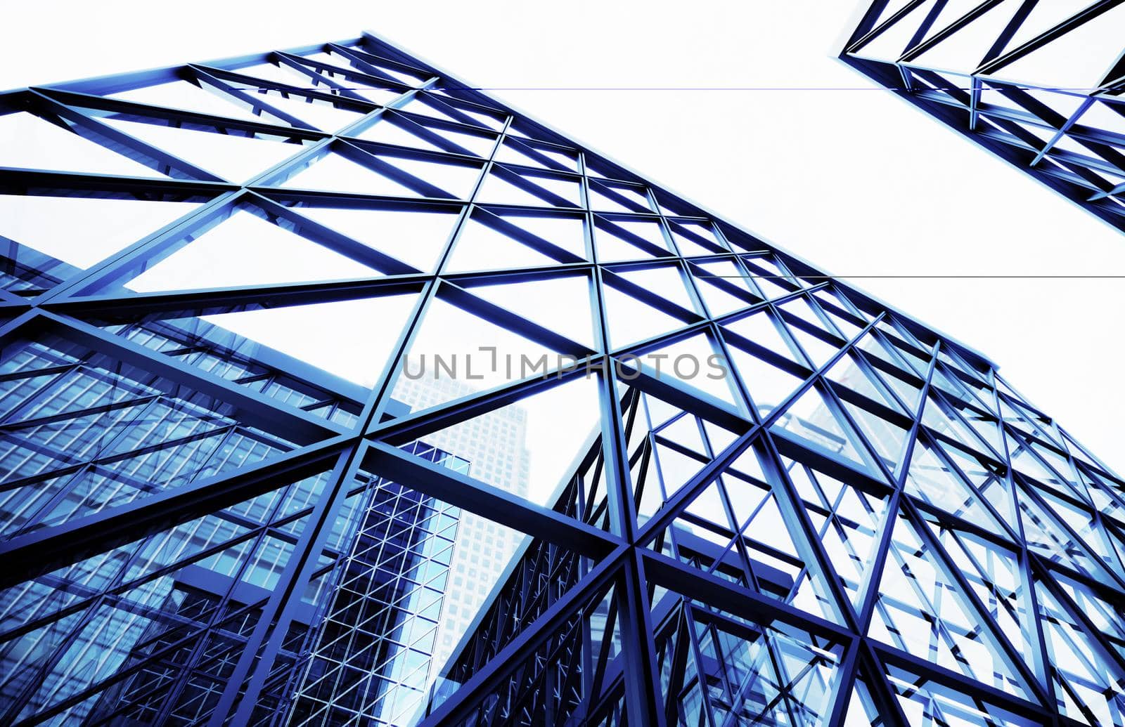 Glass buildings business concept. The glass facade of a skyscraper with a mirror reflection of sky windows. Bright sunny day with sunbeams in the blue sky. Modern buildings background. 3d Rendering