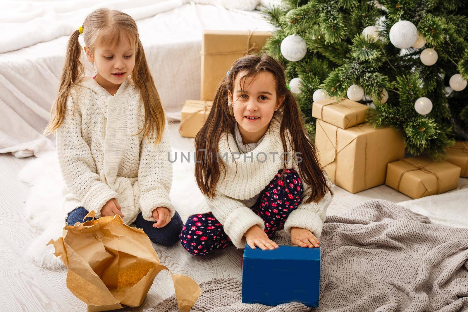 Two little girls in Christmas background.