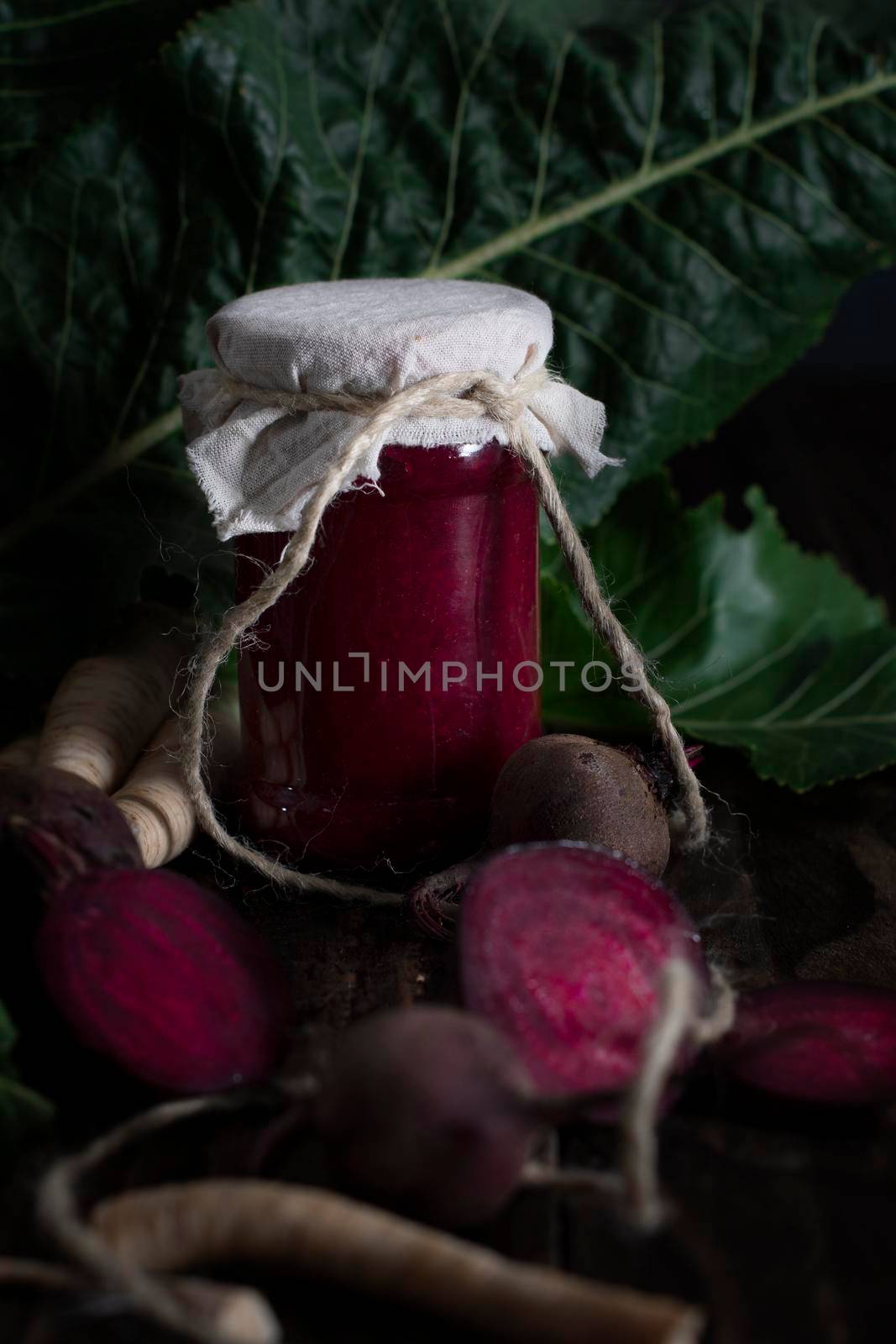 appetizer of beetroot and horseradish still life on a wooden table, seasonal twists and food preservation for the winter, photo in a dark key. High quality photo