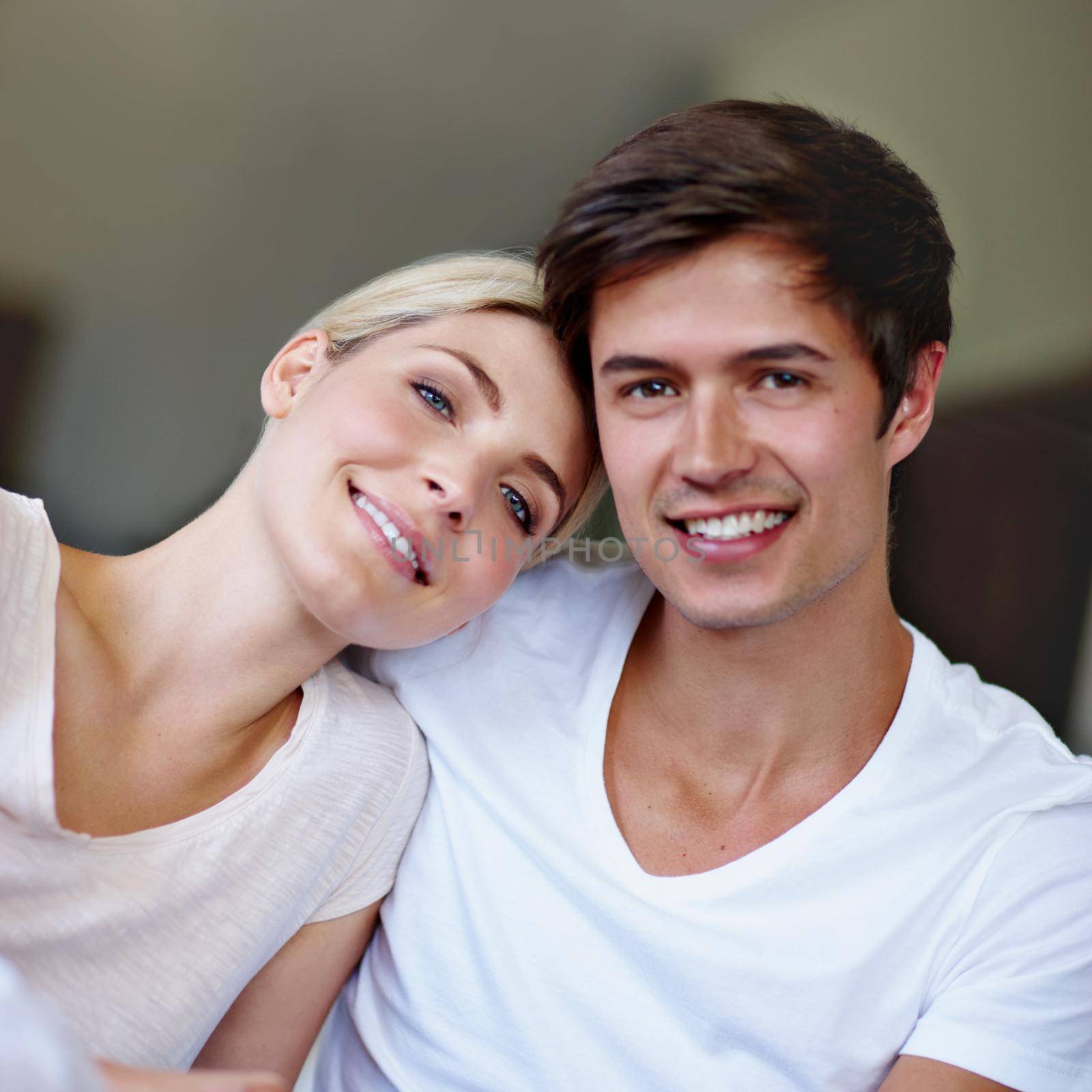 We fit together perfectly. Portrait of a happy young couple enjoying quality time together at home. by YuriArcurs