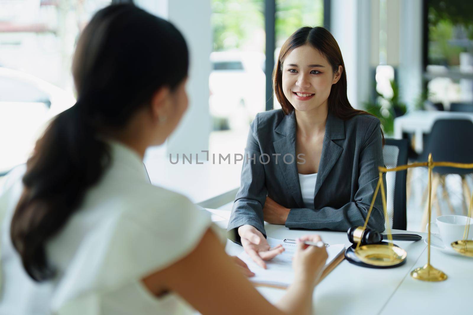 Law and legitimacy, portrait of lawyer and client signing important contract documents.