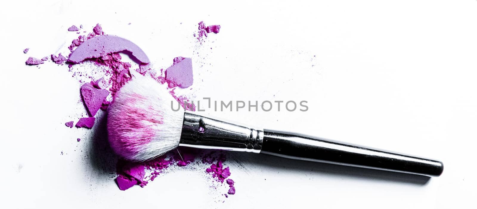 Brush with crushed eyeshadow and powder close-up isolated on white background by Anneleven