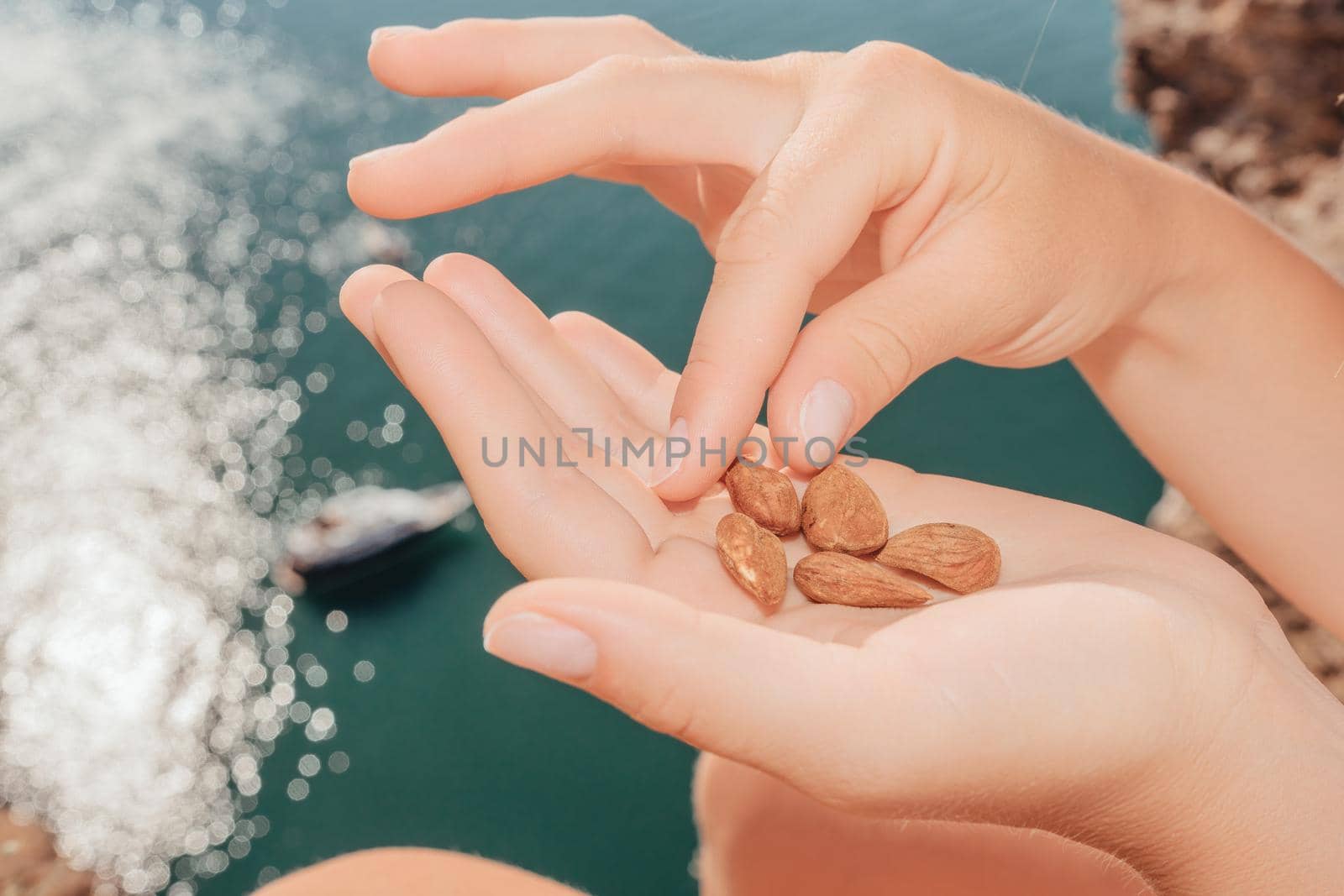 Unrecognizable caucasian woman eating young milky almond nuts. Healthy vegan food