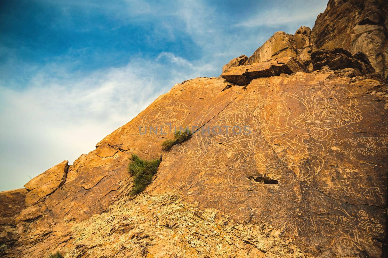 An ancient Buddha image on a stone rock on Tamgaly tas in Almaty region of Kazakhstan.