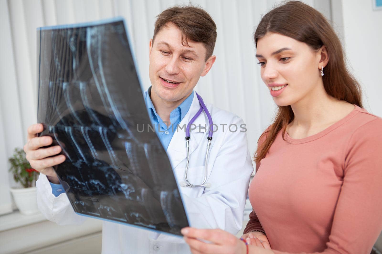 Happy healthy woman talking to her doctor after MRI scanning