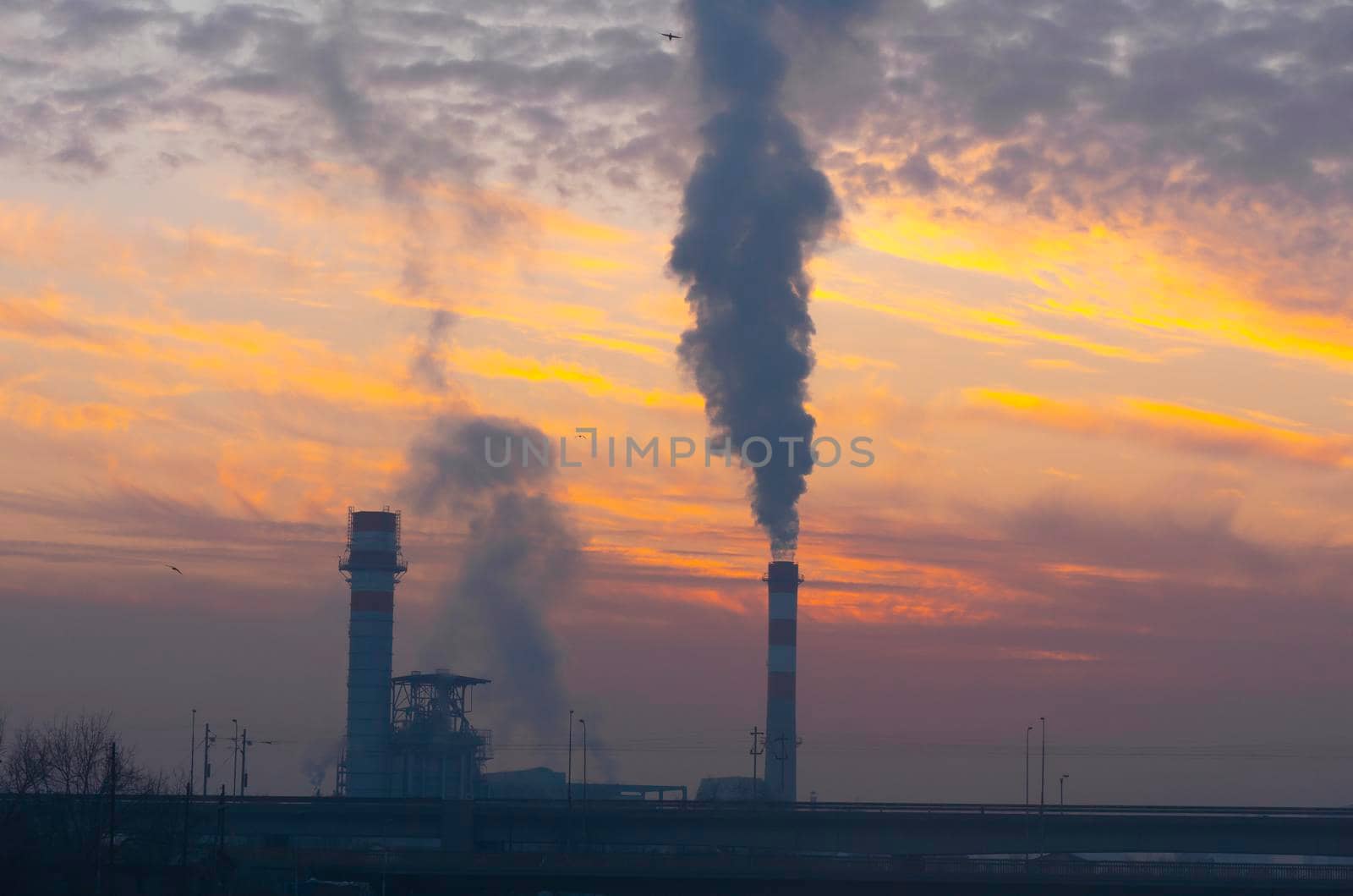 factory smoke chimney at sunrise sky clouds