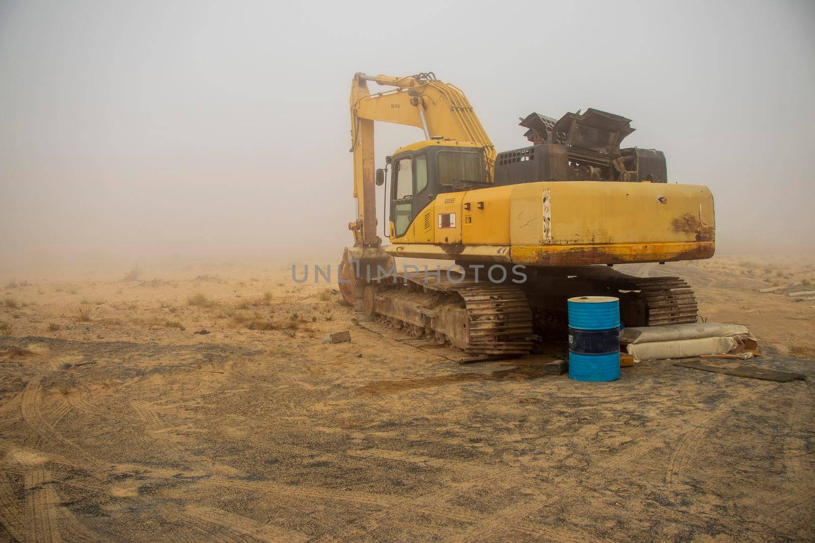 Excavator in the deserted road on the foggy morning, Outdoors