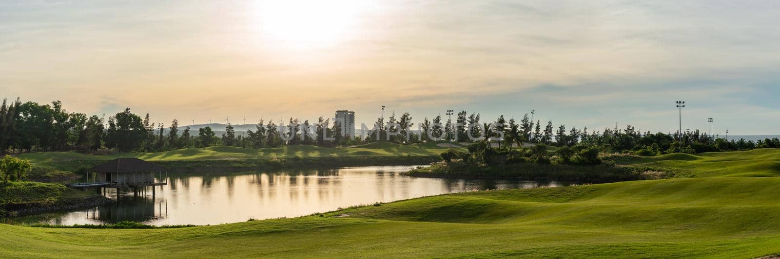 BANNER LONG FORMAT, crop it. Orange dawn sun golf pond reflection hills green fabulous background.