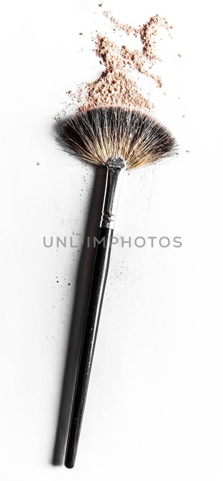 Beauty texture, cosmetic product and art of make-up concept - Brush and beige powder close-up isolated on white background