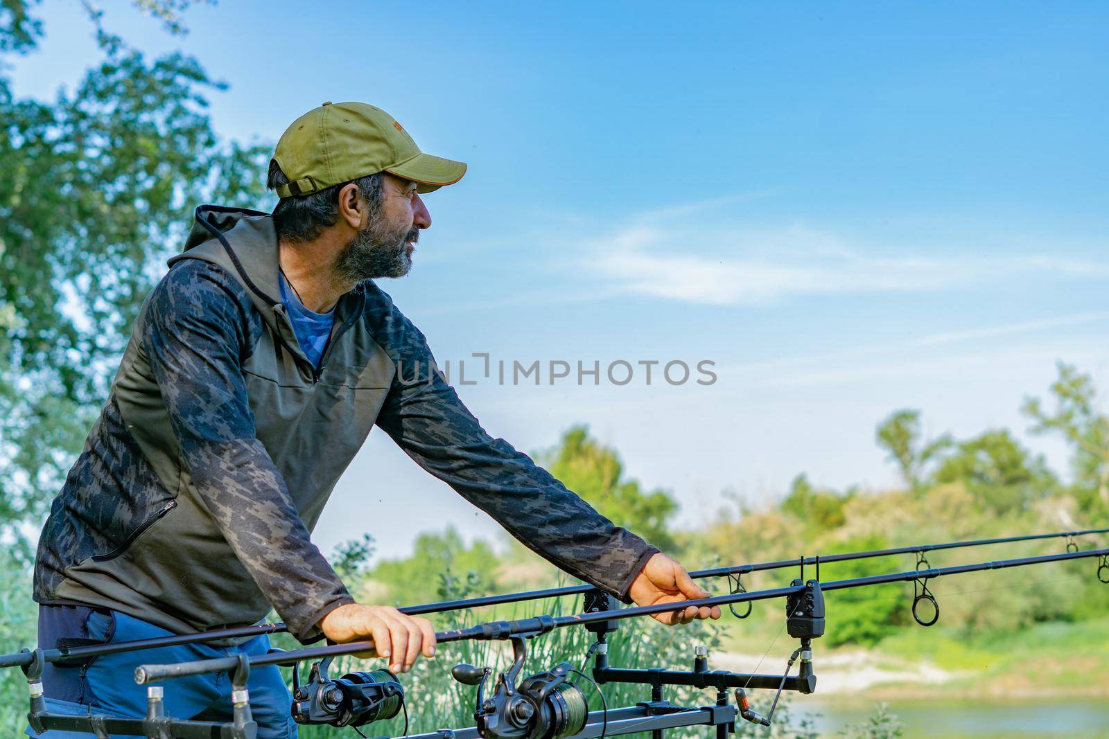 fishing session in the ebro river adult man with beard carp fishing