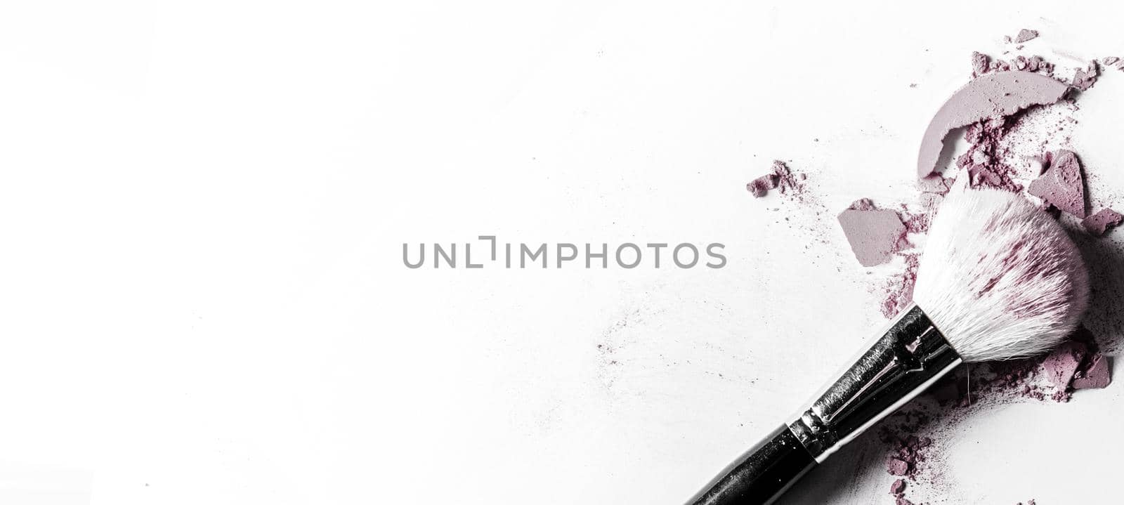 Brush with crushed eyeshadow and powder close-up isolated on white background by Anneleven