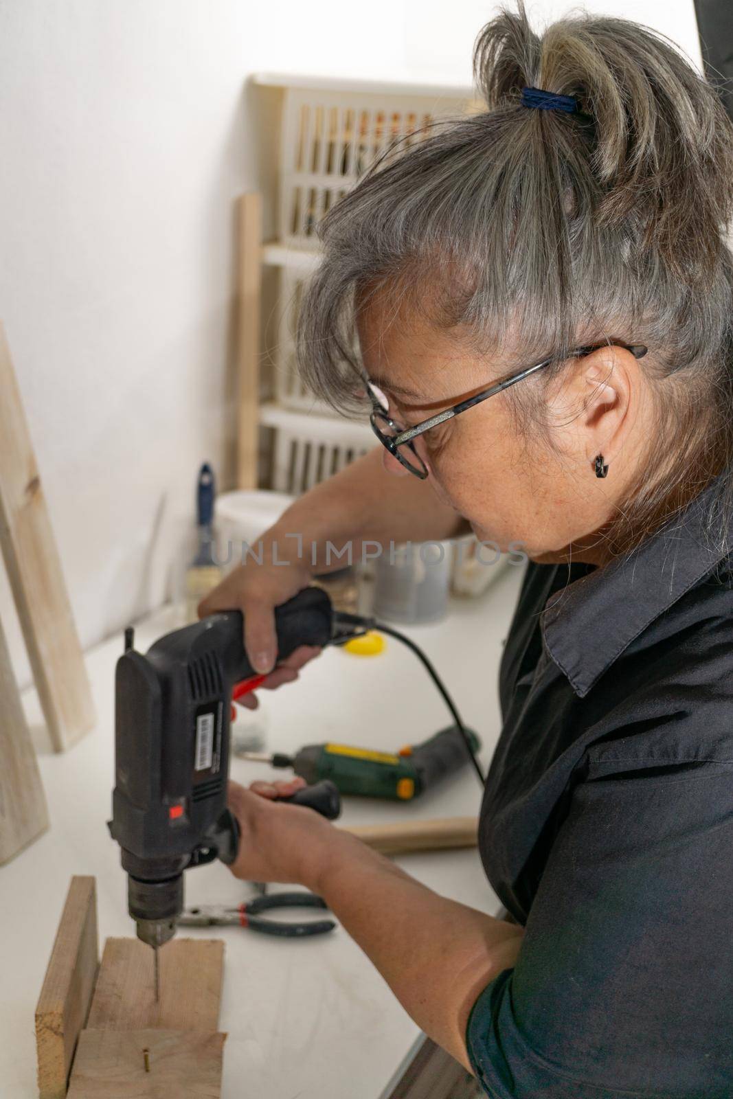older woman working in her workshop by joseantona