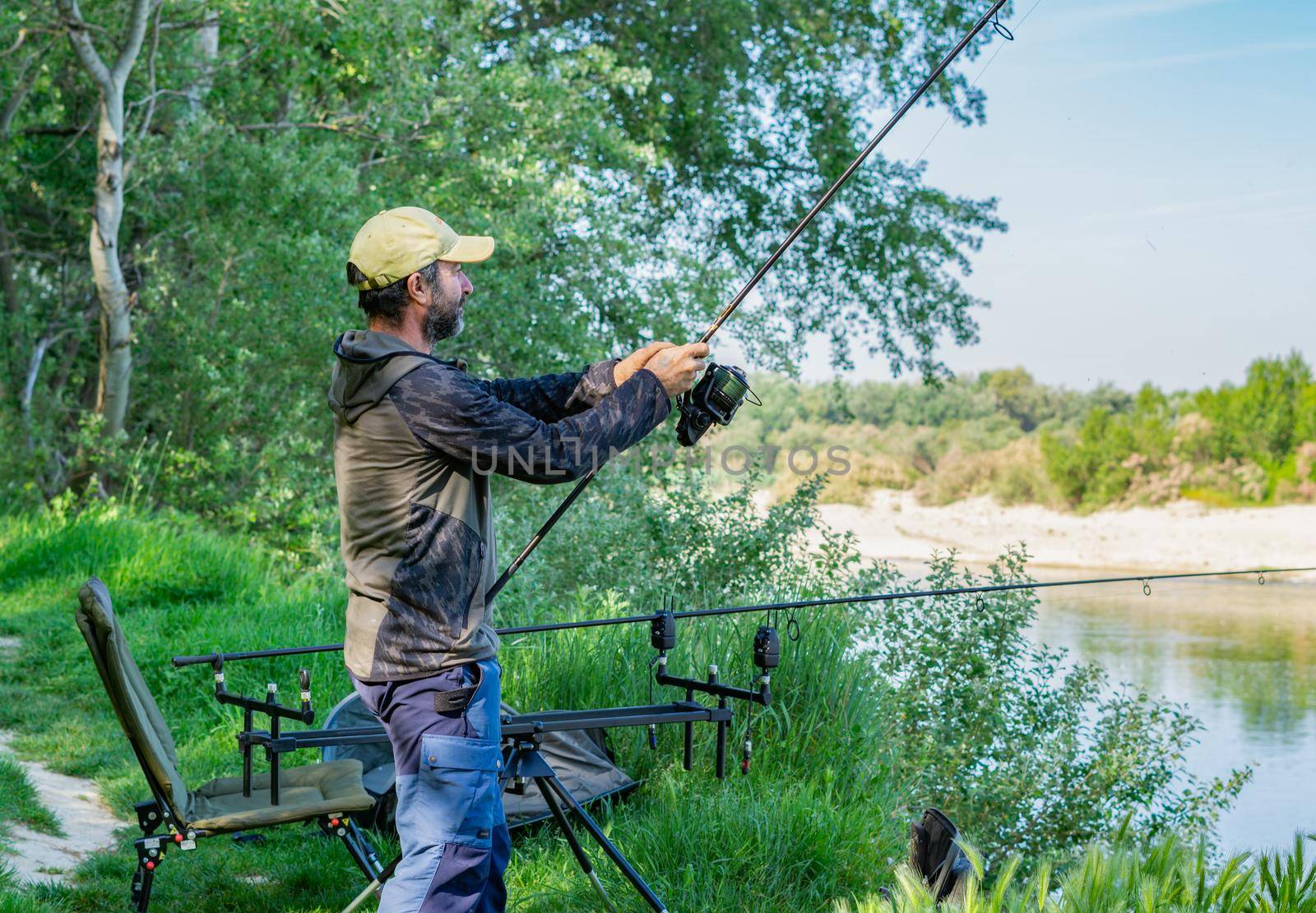 fishing session in the ebro river adult man with beard carp fishing