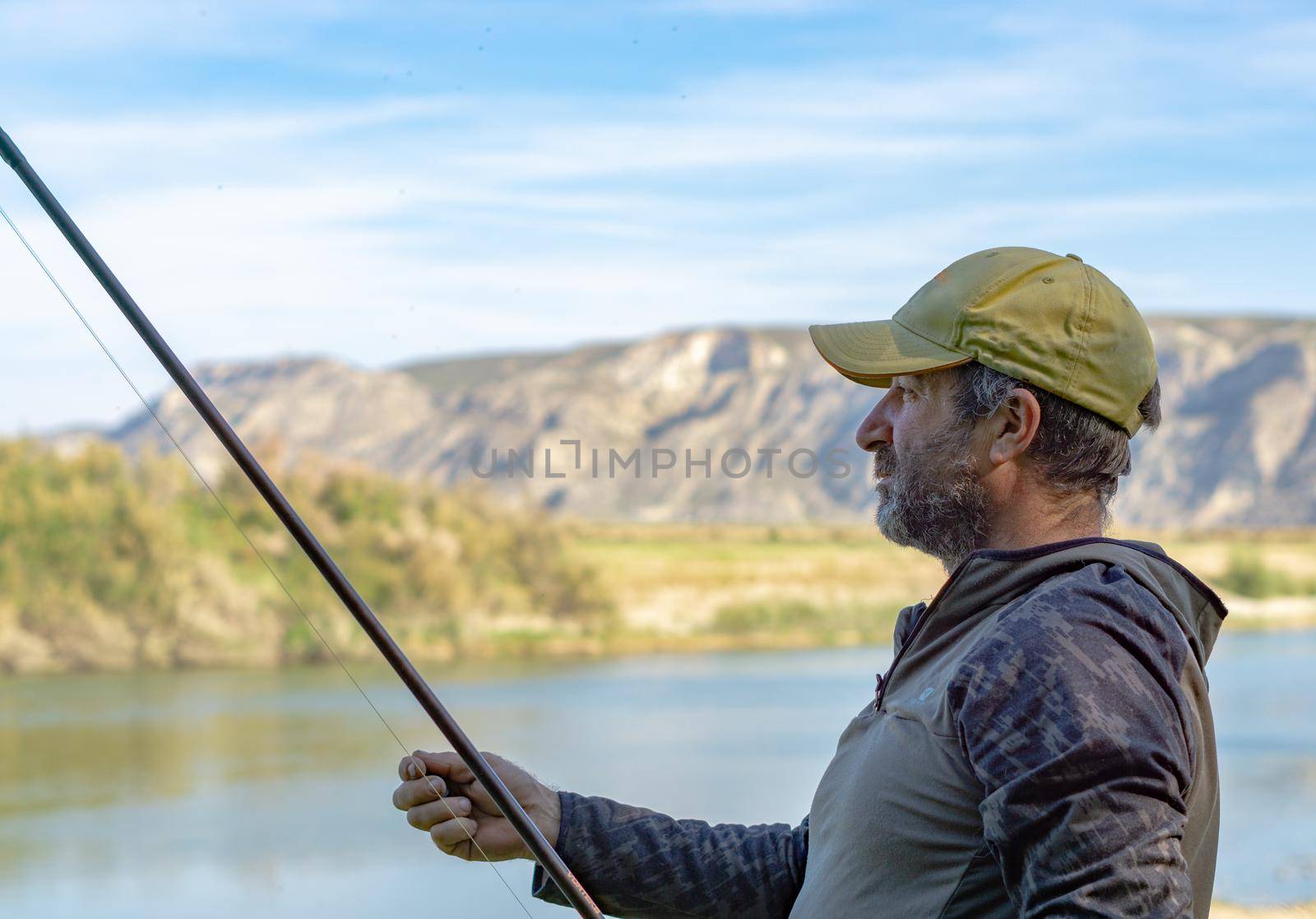 fishing session in the ebro river adult man with beard carp fishing