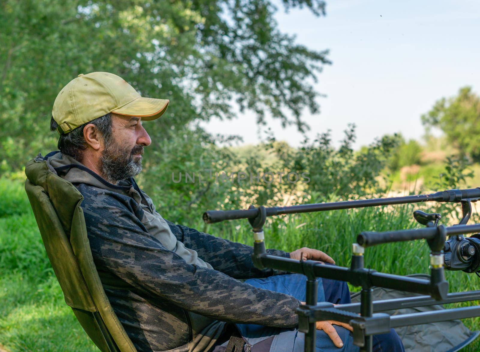 fishing session in the ebro river adult man with beard carp fishing