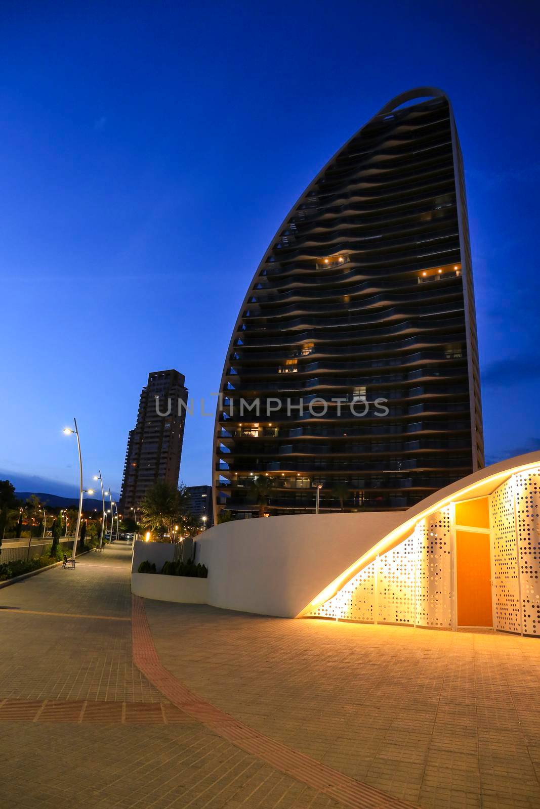 Modern architecture building on the Poniente beach Area in Benidorm at night by soniabonet