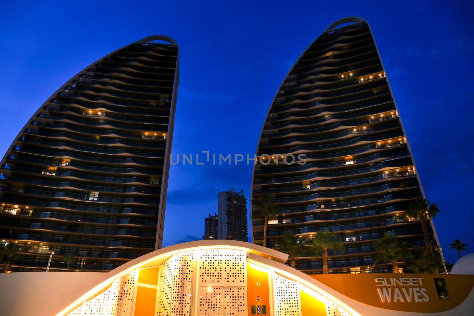 Benidorm, Alicante, Spain- September 11, 2022: Modern architecture buildings called Sunset Waves on the Poniente Beach Area in Benidorm at night