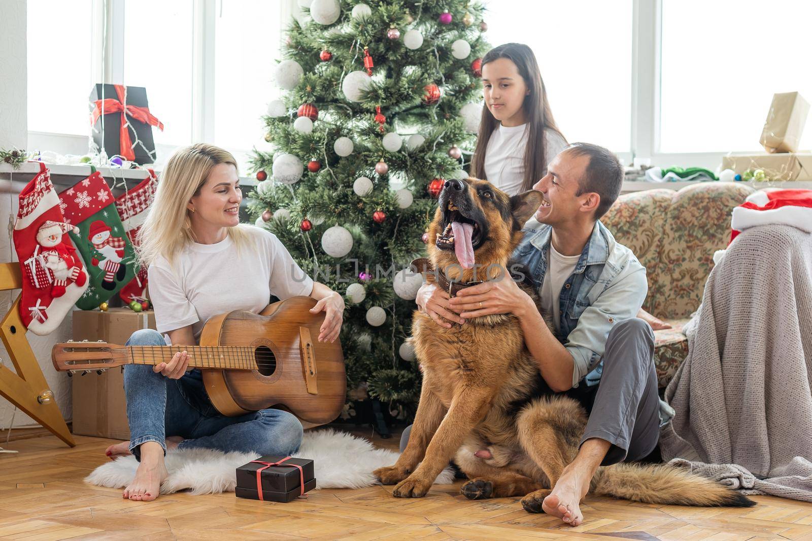 Christmas Family Portrait In Home Holiday Living Room, Kid and dog play, Present Gift Box, House Decorating By Xmas Tree.