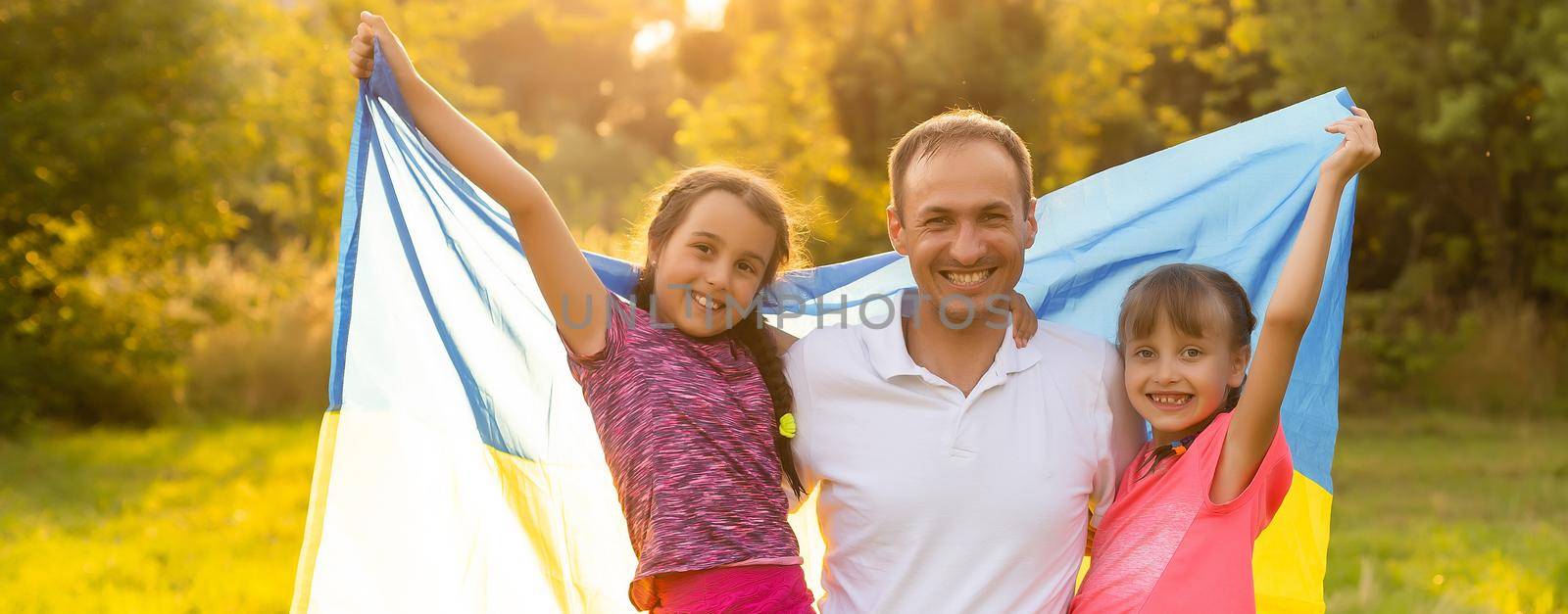happy family with flag of ukraine in field. lifestyle by Andelov13