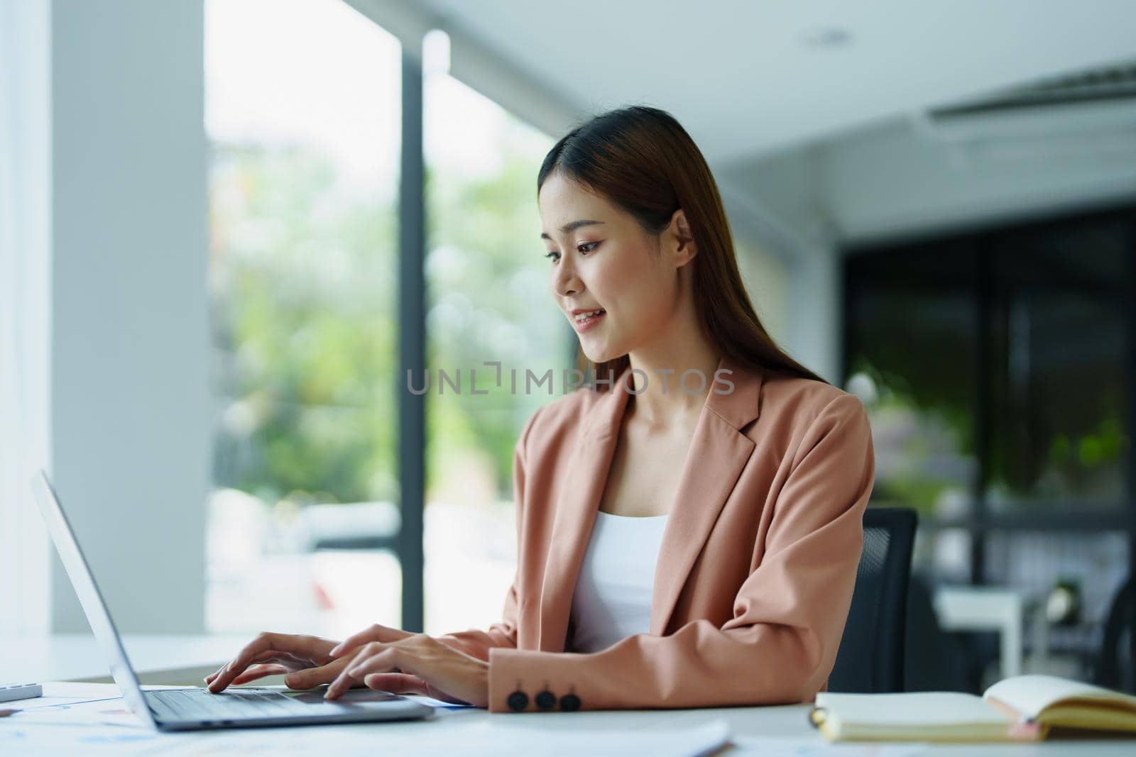 Portrait of a beautiful young woman working on a computer