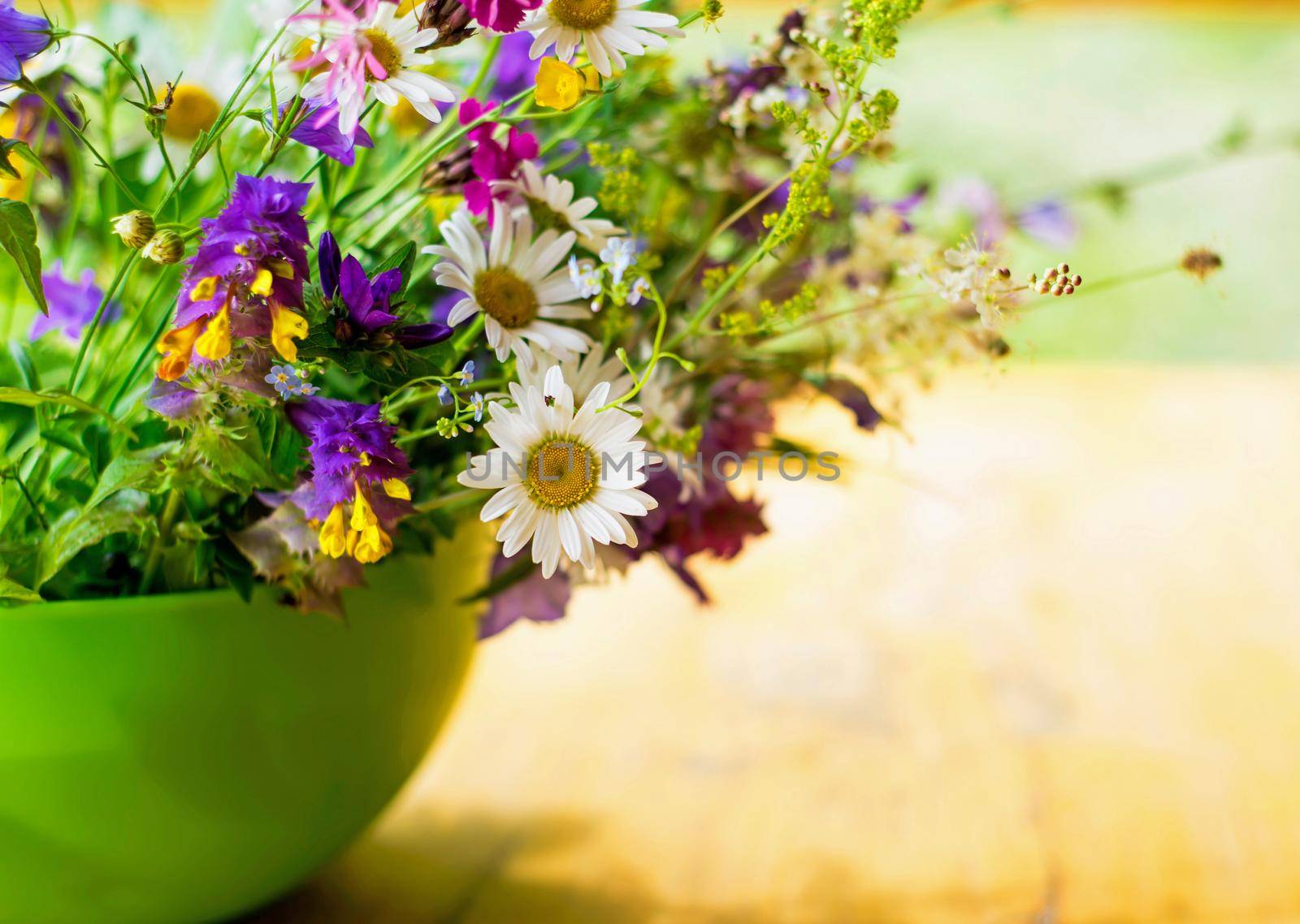 bouquet of wild flowers on a wooden background