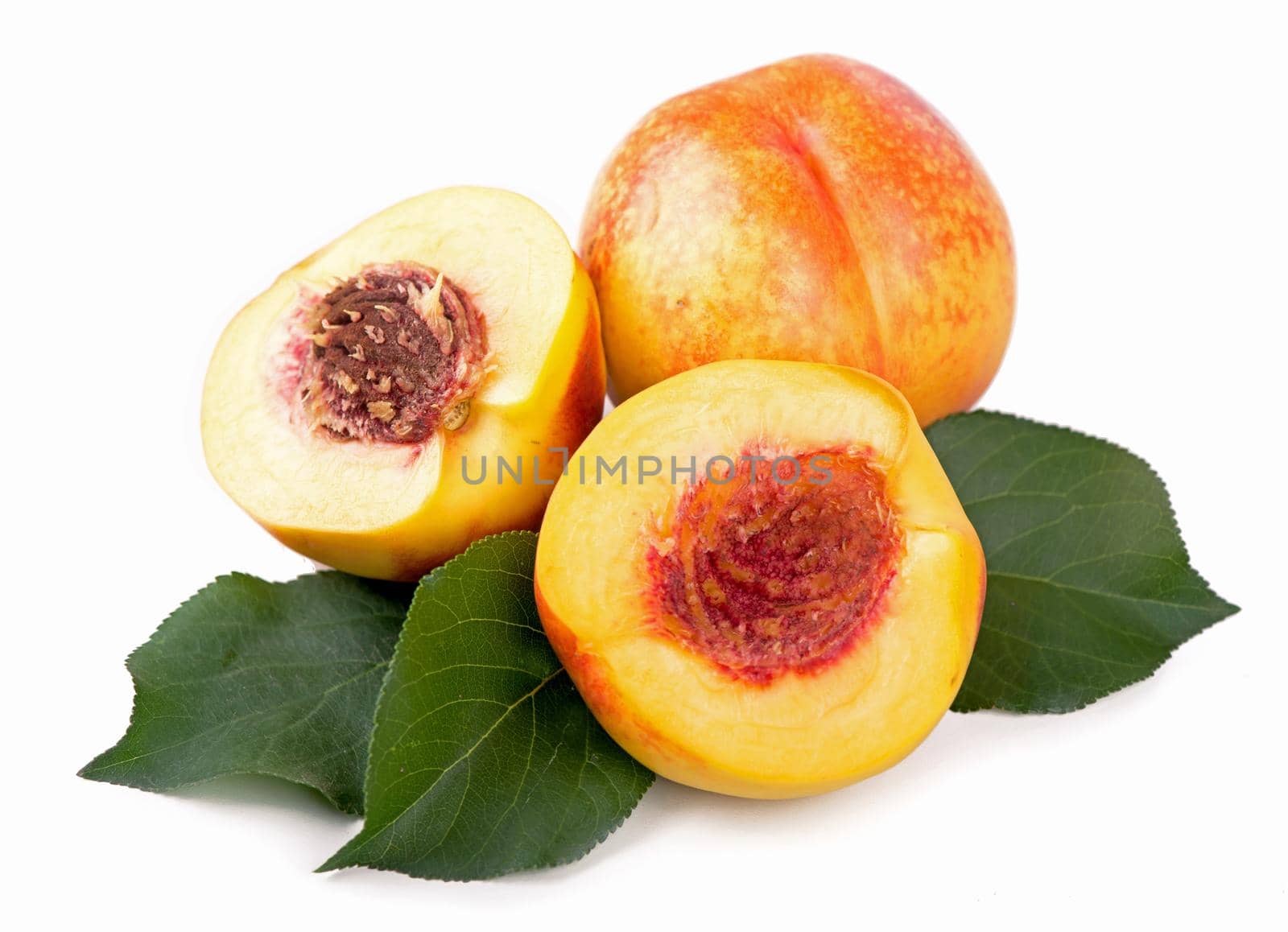 fresh nectarines with leaves isolated on white background.