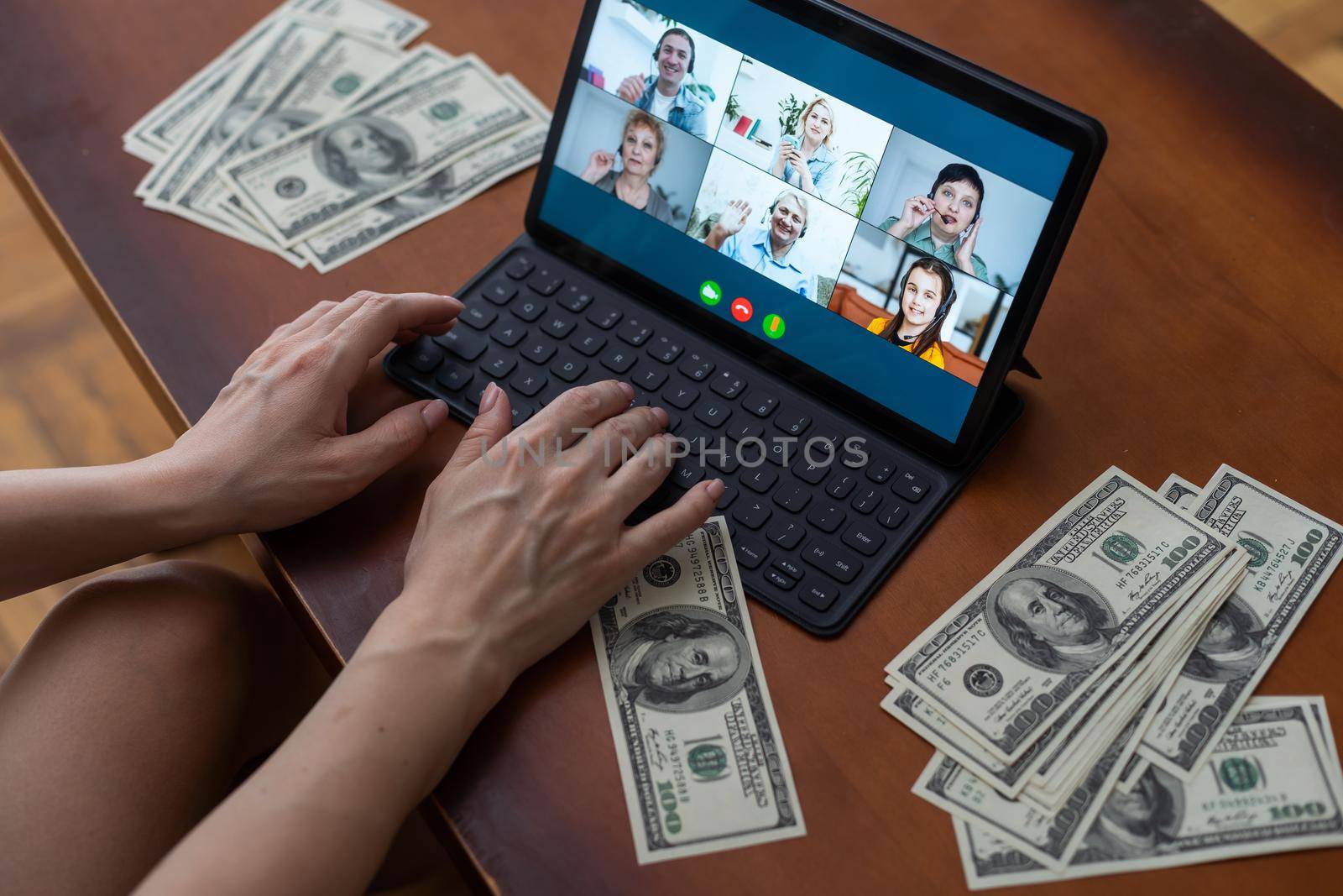 dollars and a tablet with chat in a desk.