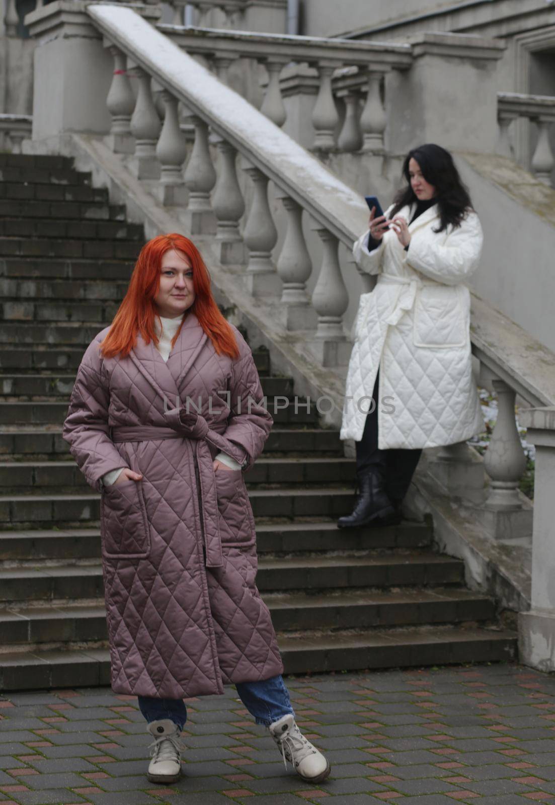 Two plus size women pose against the backdrop of a beautiful old city staircase. by gelog67