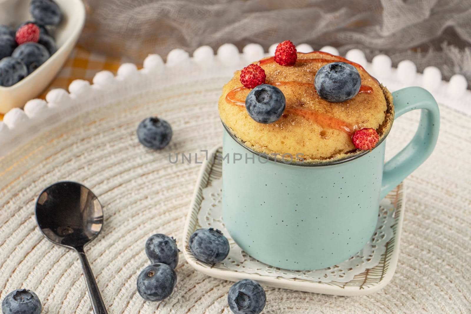 Delicious homemade blueberry muffin mug cake with fresh berries by Suietska