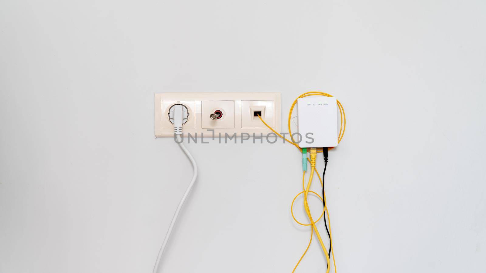 Socket with tangled wires, cables and Internet router on a white background. High quality photo