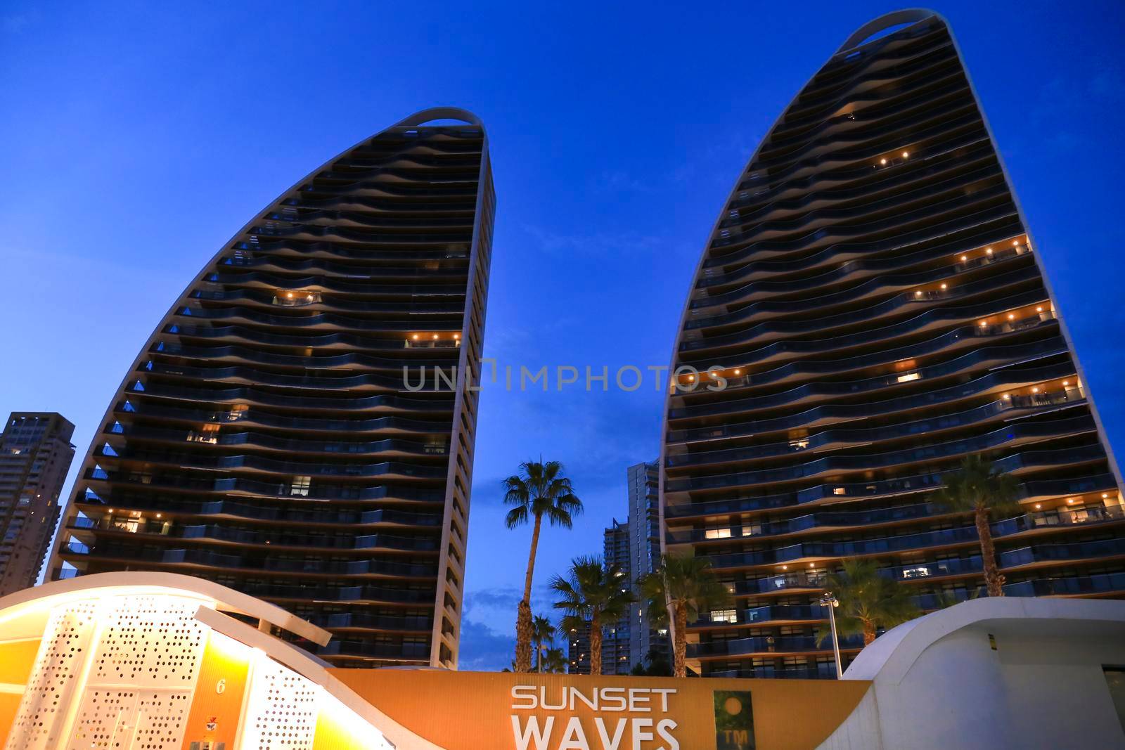 Benidorm, Alicante, Spain- September 11, 2022: Modern architecture buildings called Sunset Waves on the Poniente Beach Area in Benidorm at night