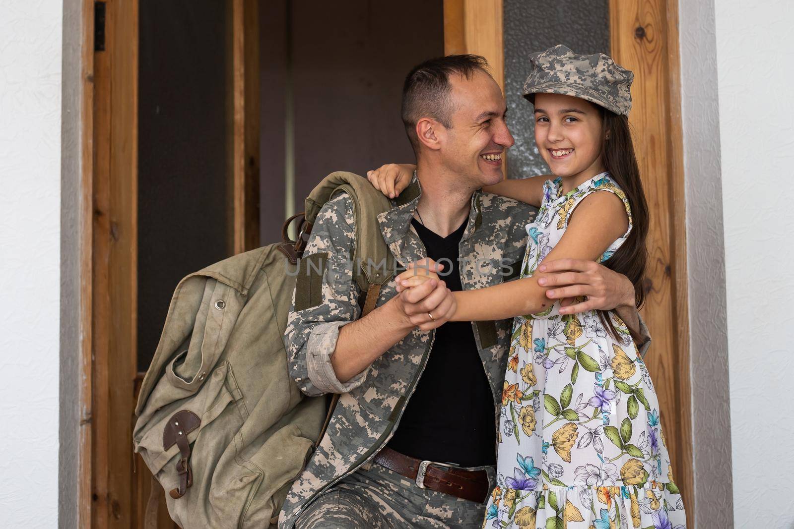 Affectionate military father with daughter at home