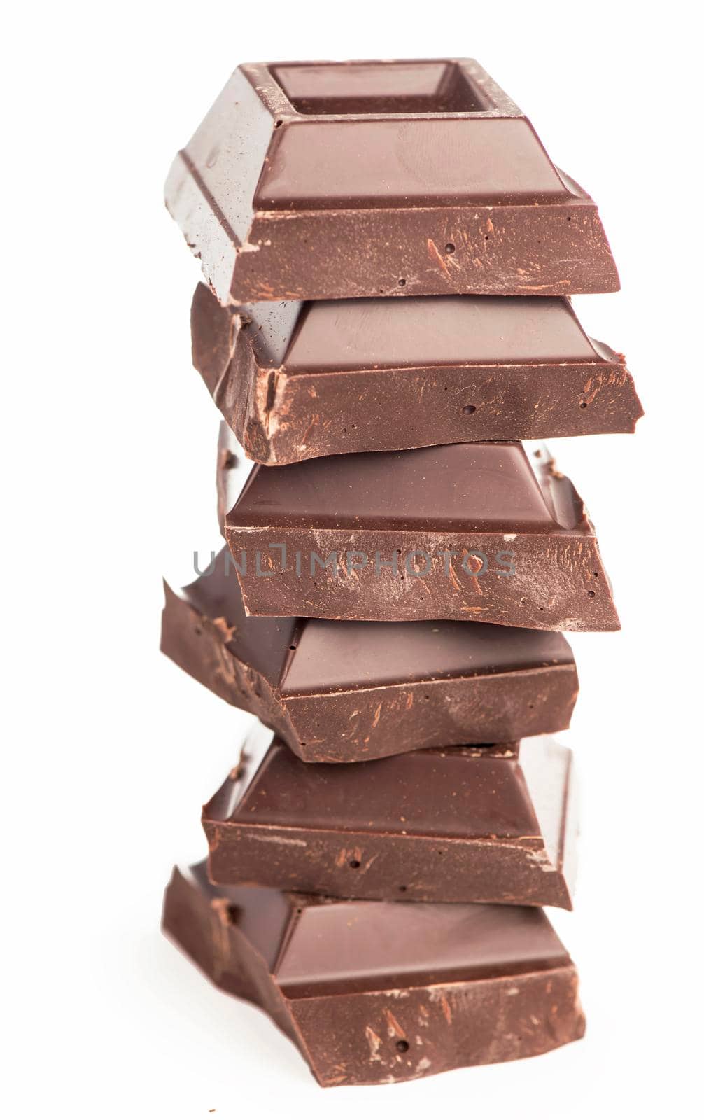 chocolate pieces. dark chocolate bars stacked high by aprilphoto