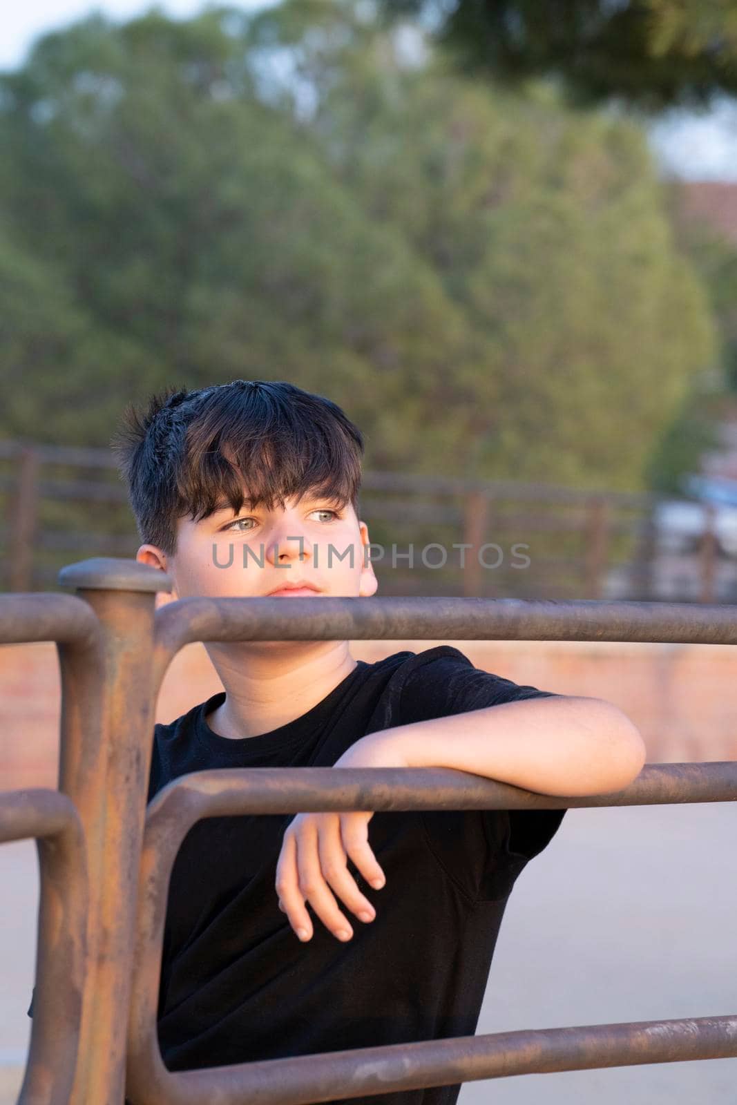 Portrait of handsome boy focused looking at sunset. Teenager with thoughtful expression. Looking ahead concept by papatonic