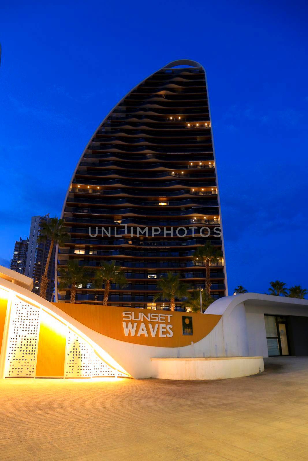 Modern architecture building on the Poniente beach Area in Benidorm at night by soniabonet