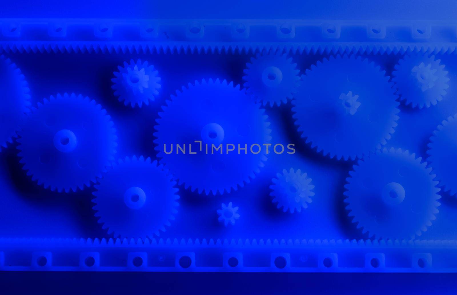 Plastic gears compilation on a neon blue background. Spare parts for your RC toy. Background picture. Sharp image.