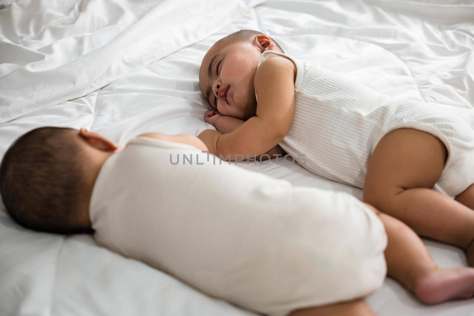 Happy childhood, Sleeping newborn identical boy twins on the bed on bedroom, Asian two adorable twin babies boy, family people infant