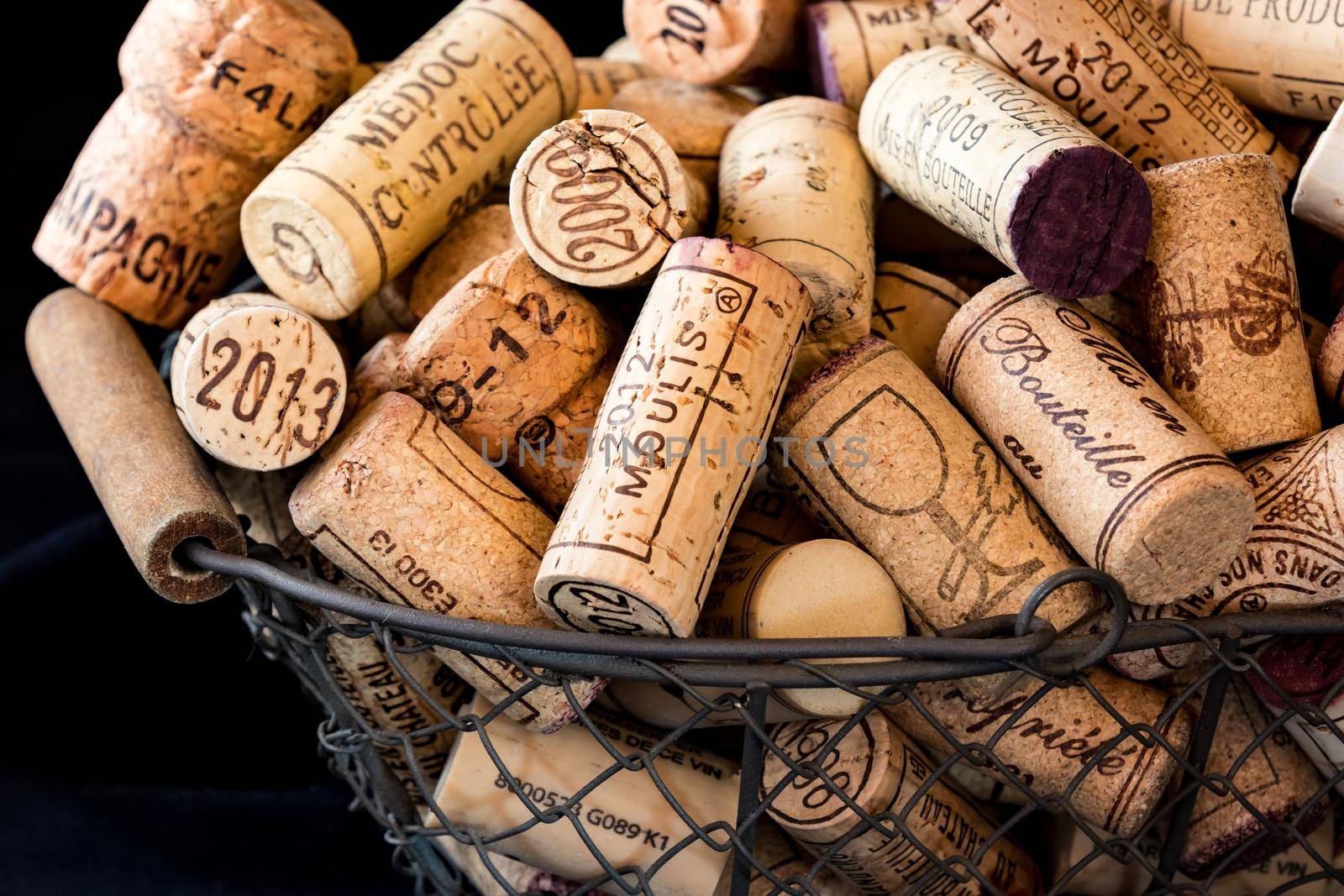 old cork stoppers of French wines in a wire basket by jp_chretien