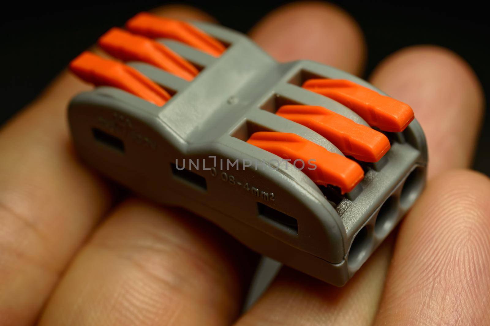 Electrical terminal for quick connection of wires on a child's hand - close-up photo. Background picture. . High quality photo