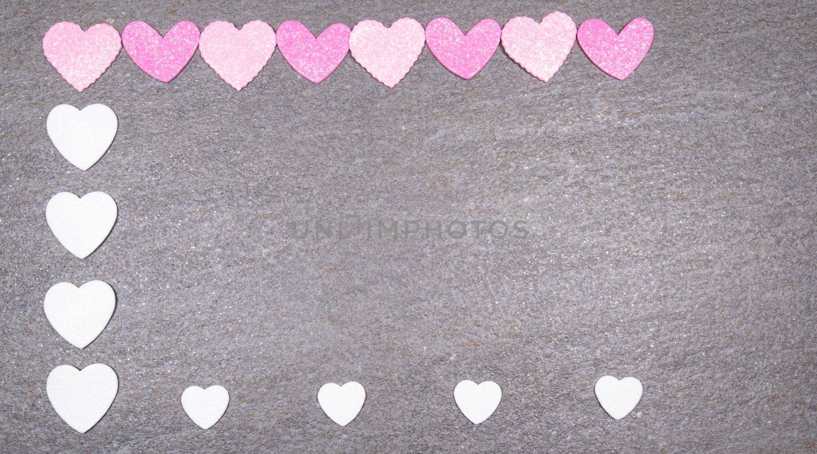 gray granite background with pink and white hearts for valentines day. Valentine's day and love concept by jp_chretien