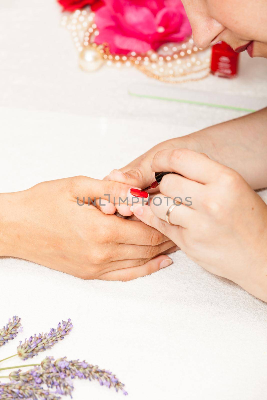 Applying nail polish on a woman's hands